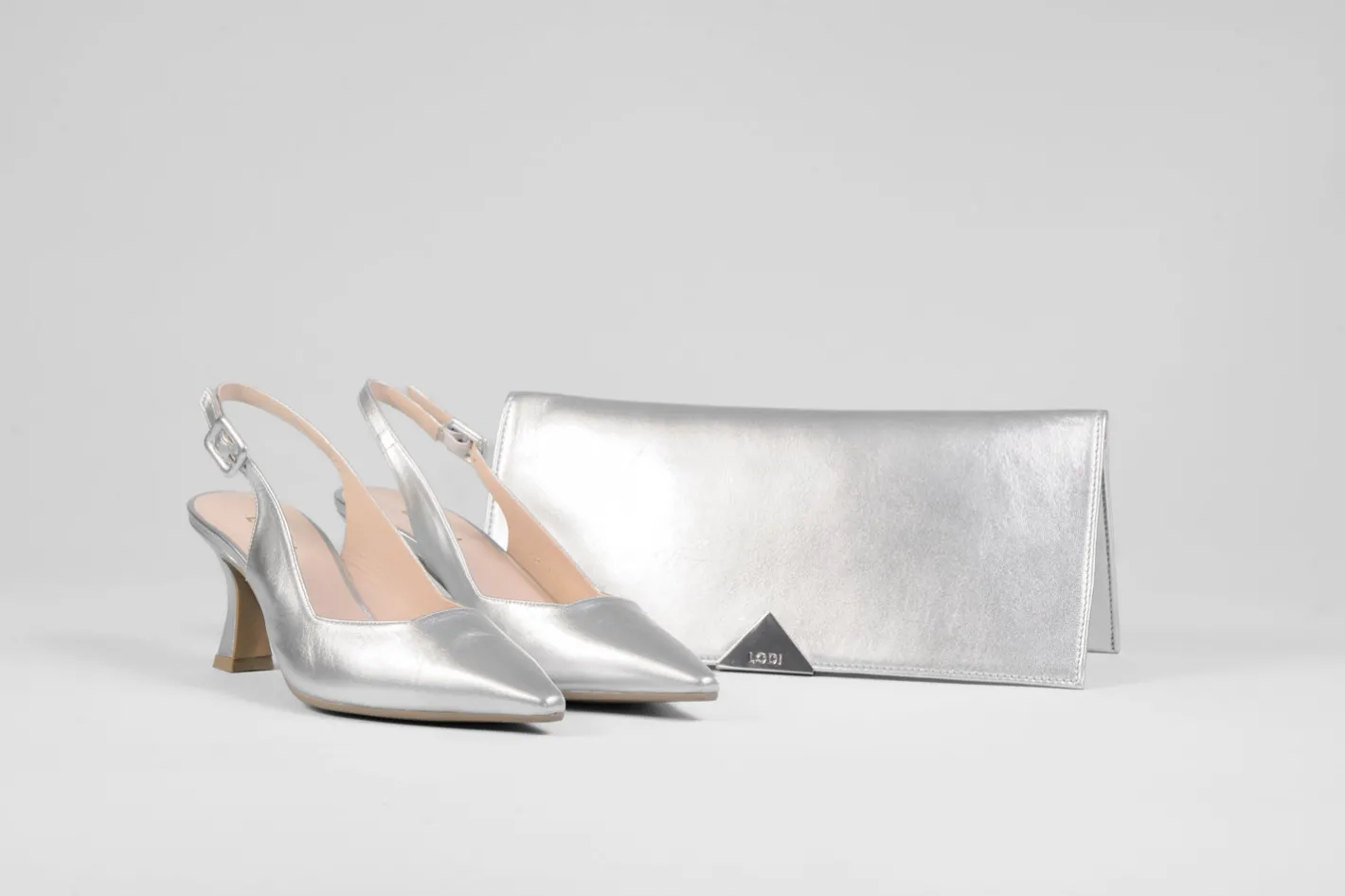 lodi__juco_silver_slingba_1.webp Lodi - Juco Silver Slingback with a kitten heel